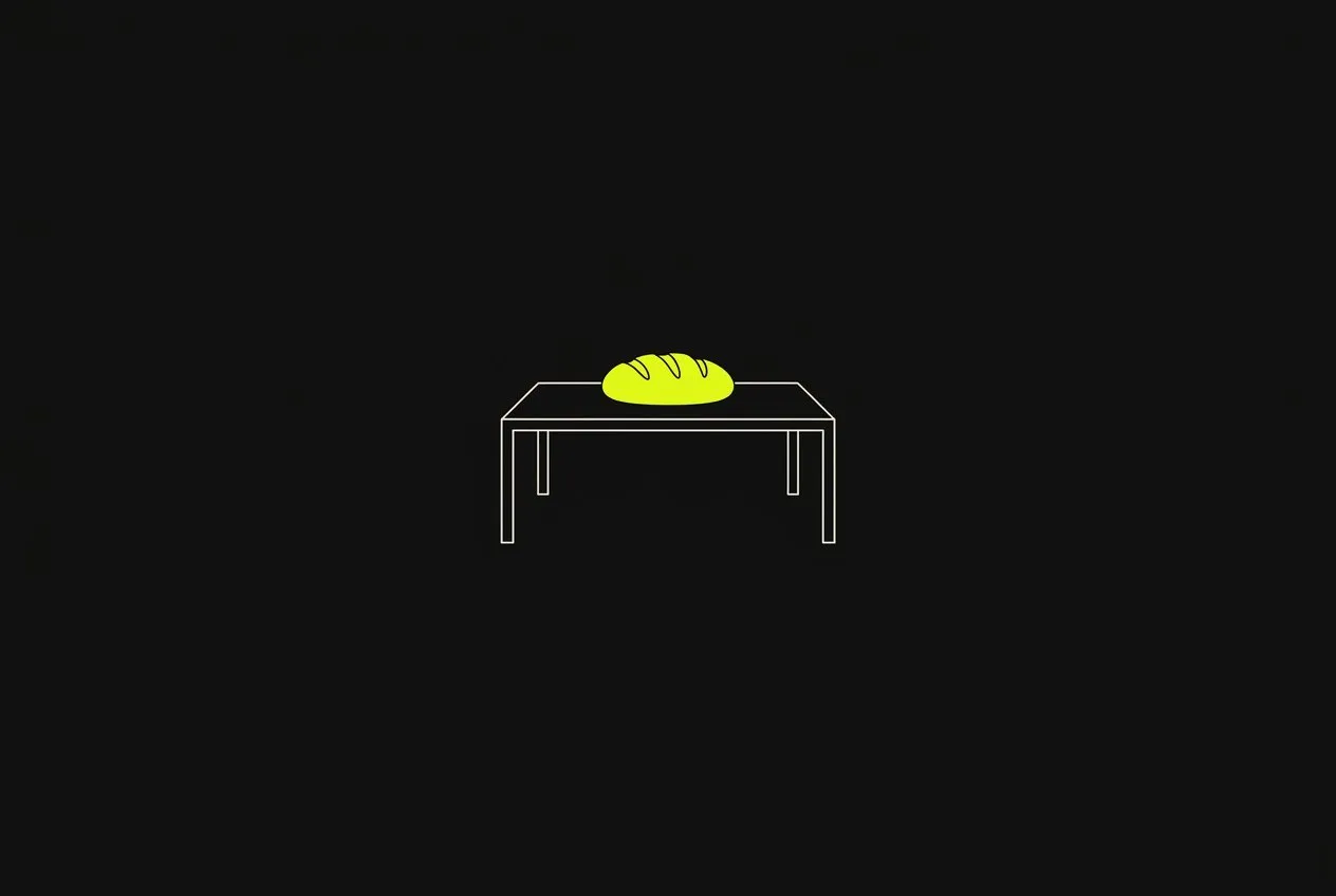 Line illustration: a simple table outline with one loaf of bread shared in the middle, the bread acid yellow.