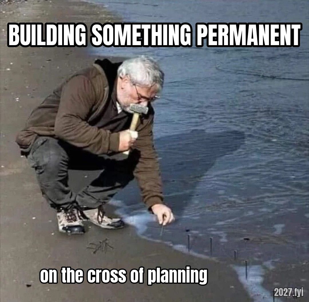 A man hammering nails into wet sand. BUILDING SOMETHING PERMANENT / on the cross of planning